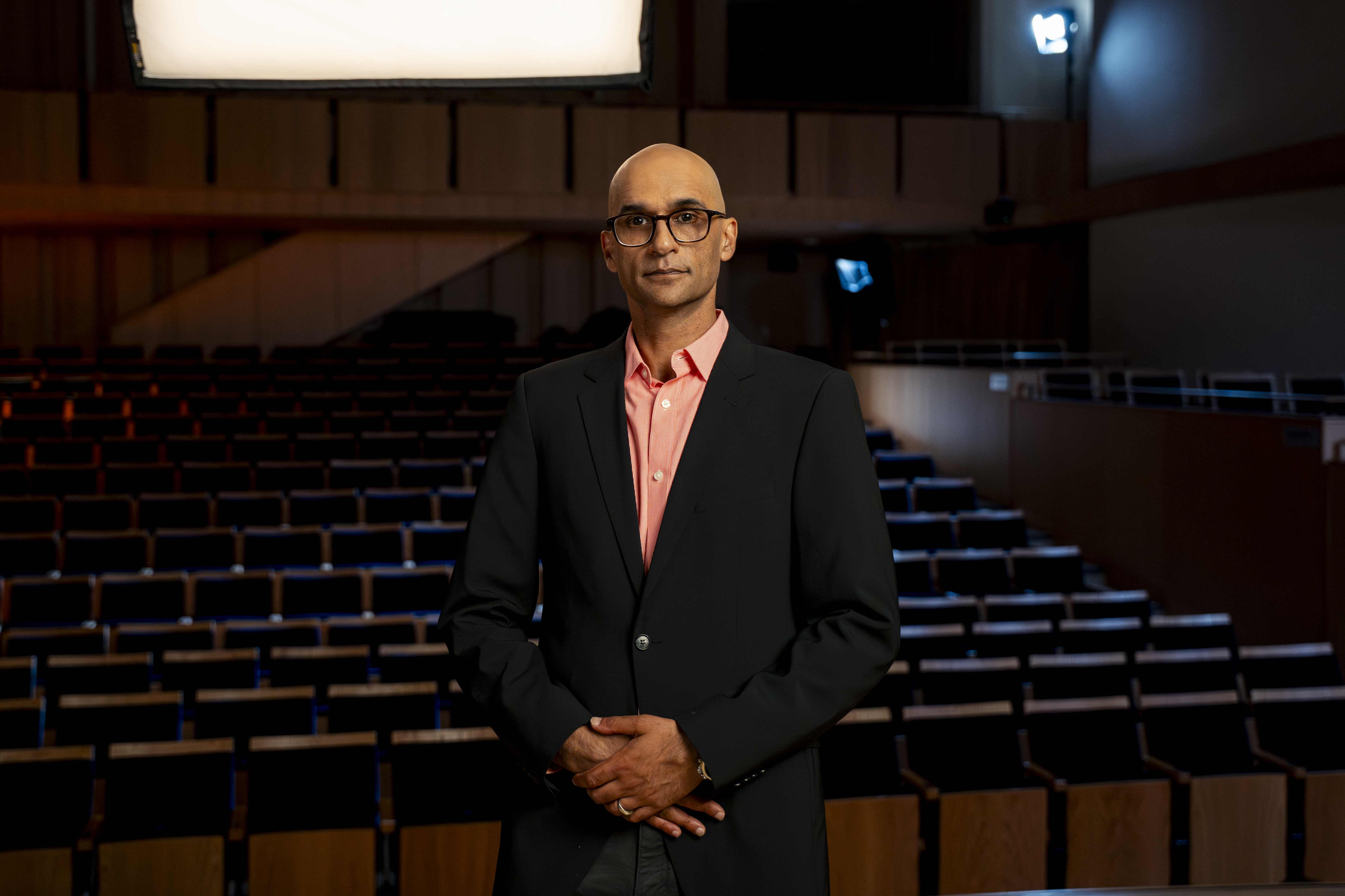 Mohit Rajhans standing in an auditorium